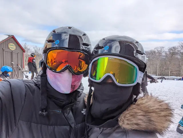 ggraph of Chris and Emily in ski masks and helmets in the snow